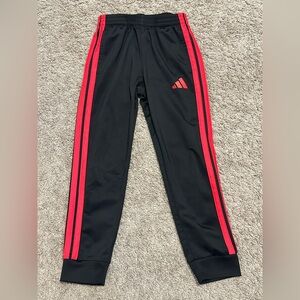 Black sweatpants with red side stripes
